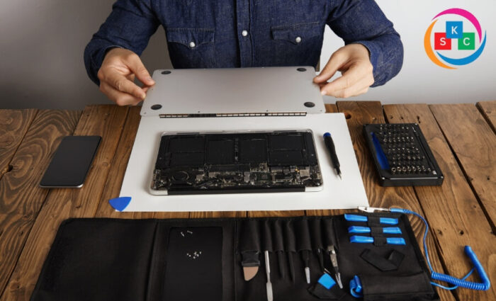 Technician performing Dell laptop motherboard replacement at a laptop repair center in Neredmet